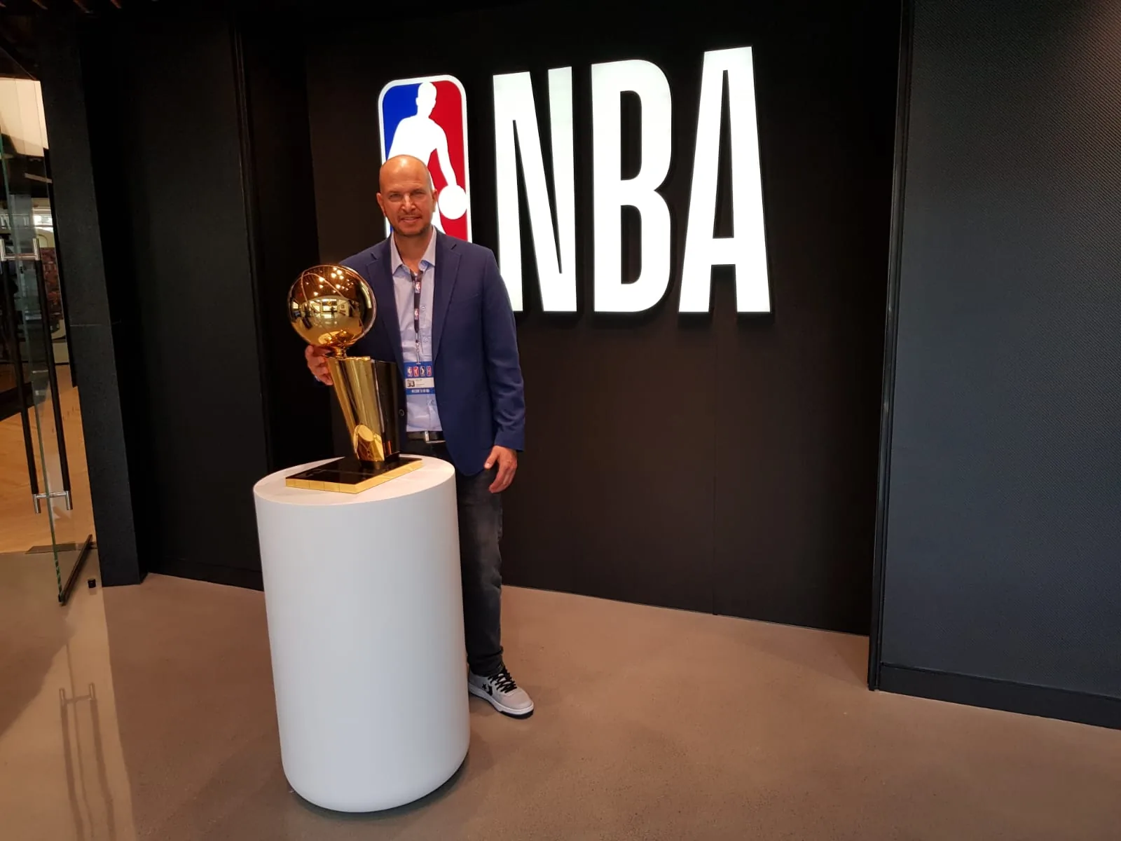 Tamir Kfir holding the NBA championship trophy at the NBA offices